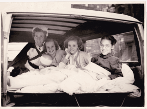 Judy in bed at the back of a car on Coronation Day
